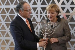 German Chancellor Merkel receives a menorah from President of the Central Council of Jews in Germany Graumann, ahead of a council meeting in Frankfurt